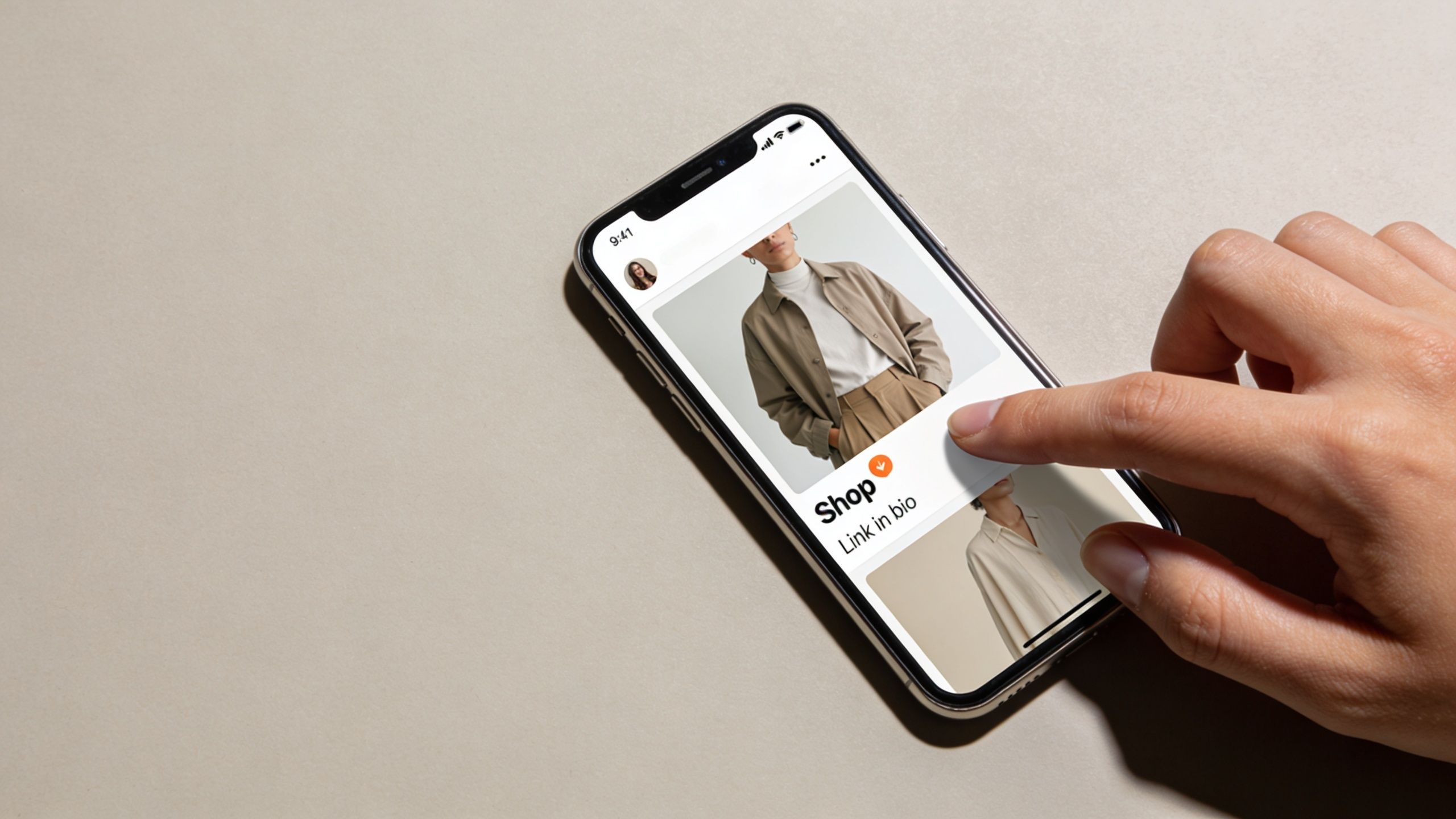 A person interacting with a mobile phone screen showing a fashion post with a shop link.