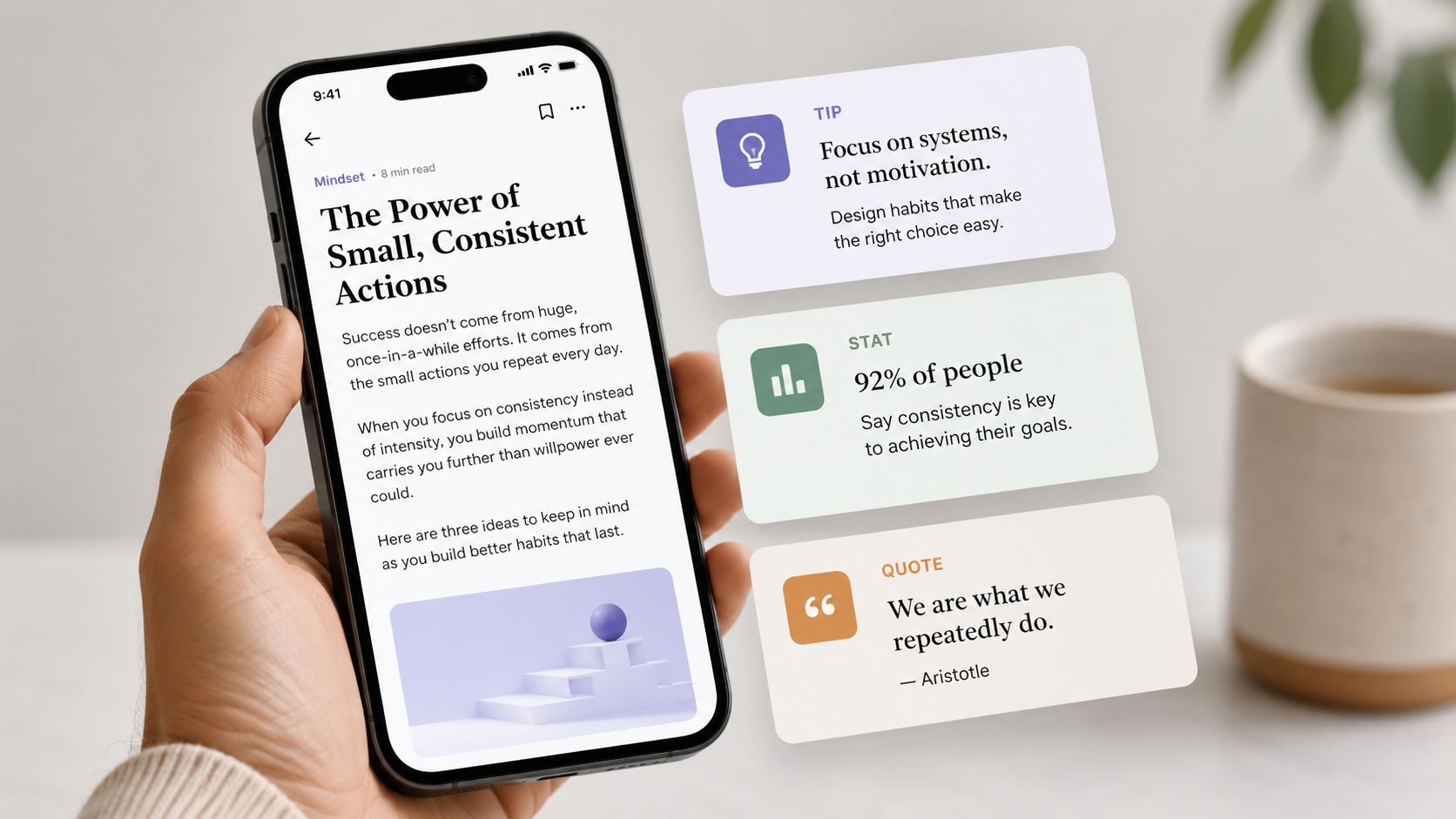 A hand holding a smartphone displaying an article about habits next to cards featuring tips, stats, and quotes.